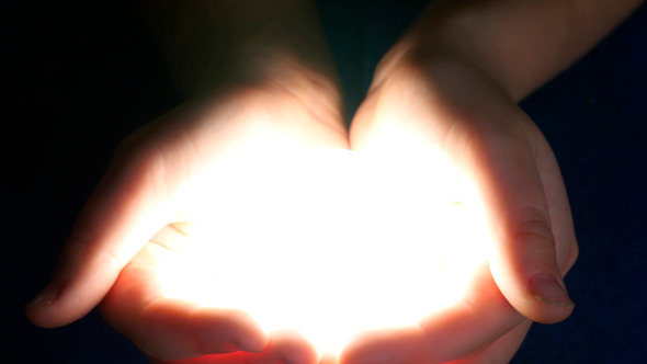 This image has an empty alt attribute; its file name is boy-holding-light-in-her-hands.jpg